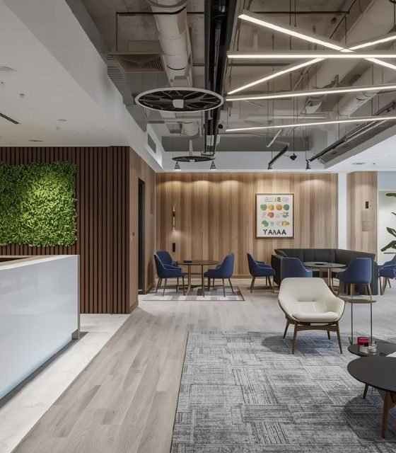 Modern office reception interior with wooden wall panels, green wall, and luxury lighting.